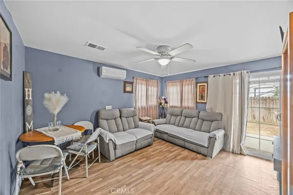 a bedroom with a bed a couch and a chandelier