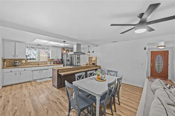 a kitchen with a table chairs stove and cabinets
