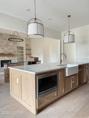 a kitchen with cabinets a sink and appliances