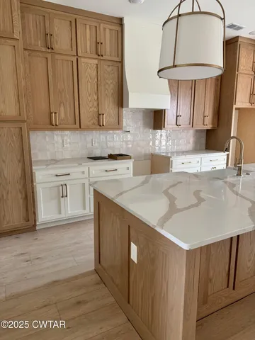 a kitchen with stainless steel appliances granite countertop a sink a stove and a microwave