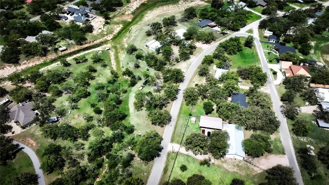 an aerial view of a house with a lush green forest