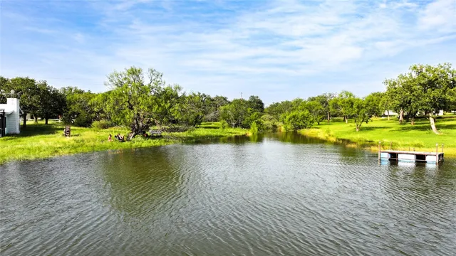 a view of a lake with houses in the back