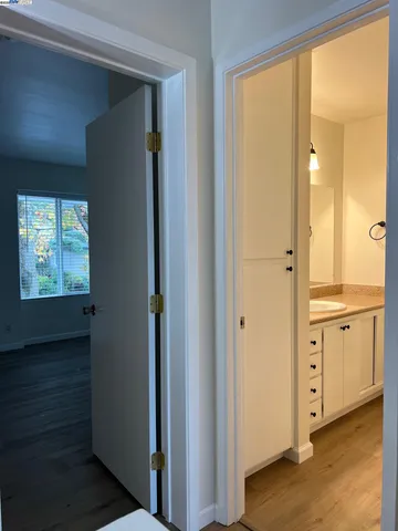 a view of walk in closet with wooden floor