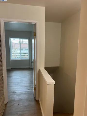 a view of hallway with wooden floor and front door