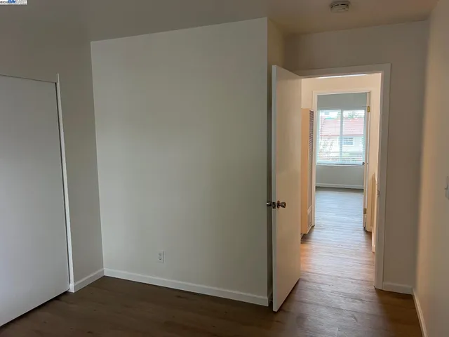 a view of a room with wooden floor