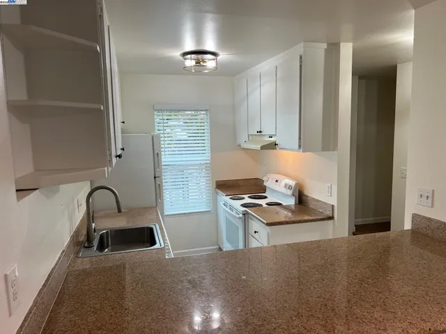 a kitchen with a sink cabinets and window