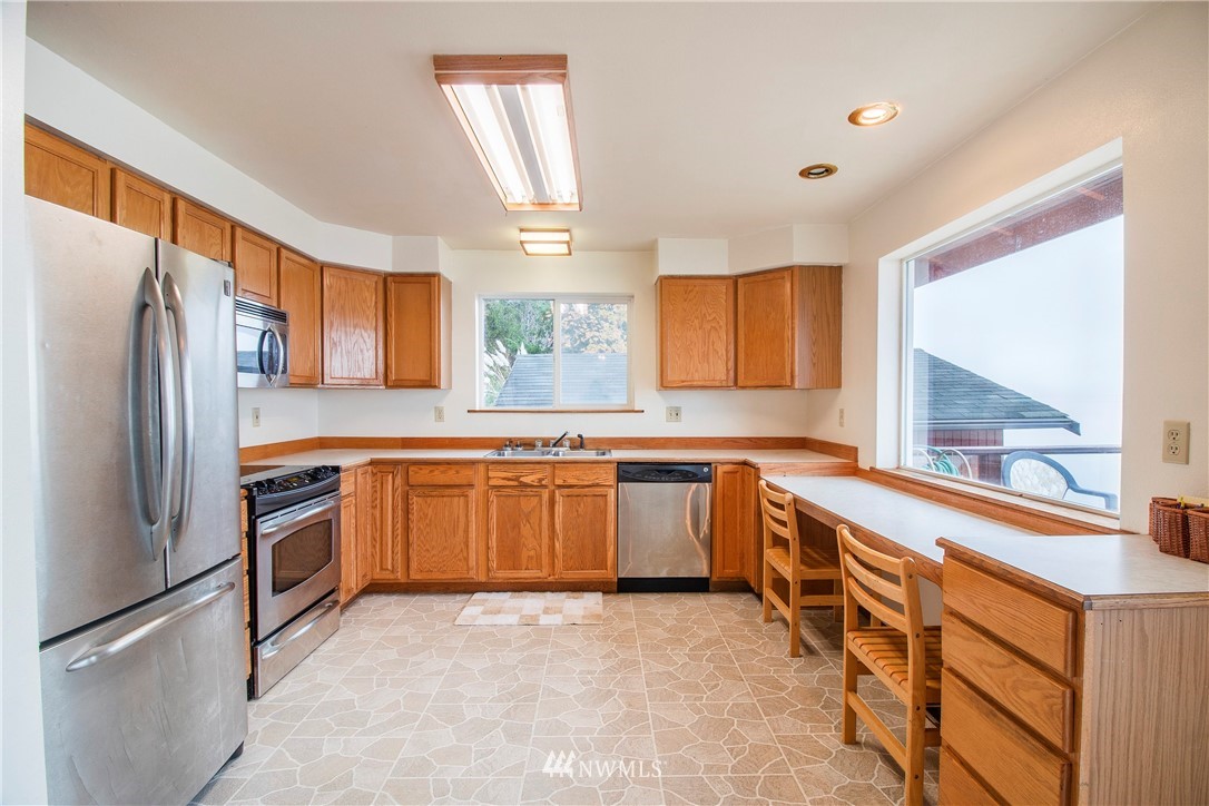 7971 Northeast North Shore Road Belfair, WA 98528 - Photo 13 of 25 a kitchen with stainless steel appliances granite countertop a refrigerator and a stove top oven