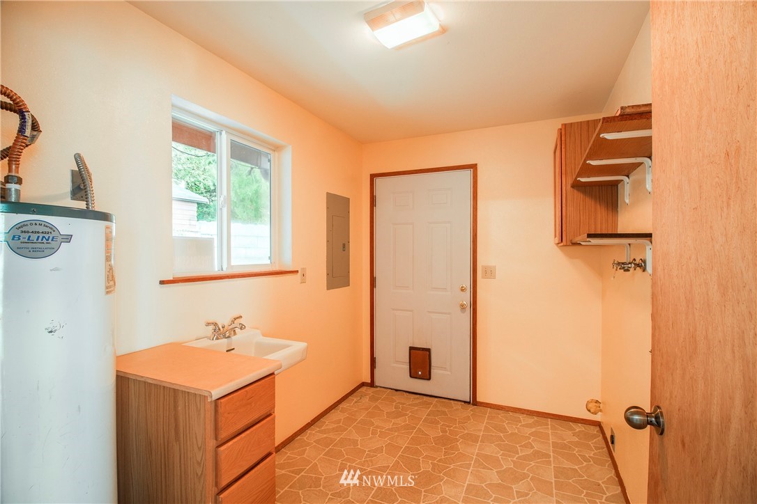 7971 Northeast North Shore Road Belfair, WA 98528 - Photo 17 of 25 a bathroom with a sink a mirror and shower