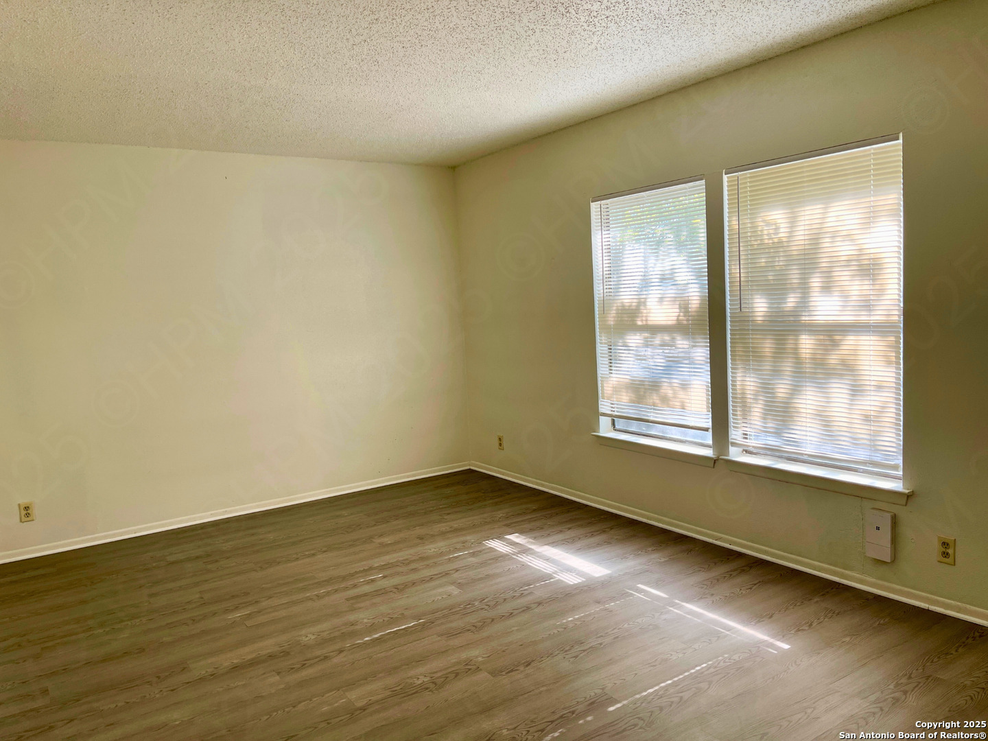 7315 Ridge Beach Drive Converse, TX 78109 - Photo 12 of 17 an empty room with wooden floor and windows