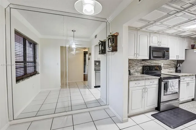 a kitchen with stainless steel appliances a refrigerator sink and microwave