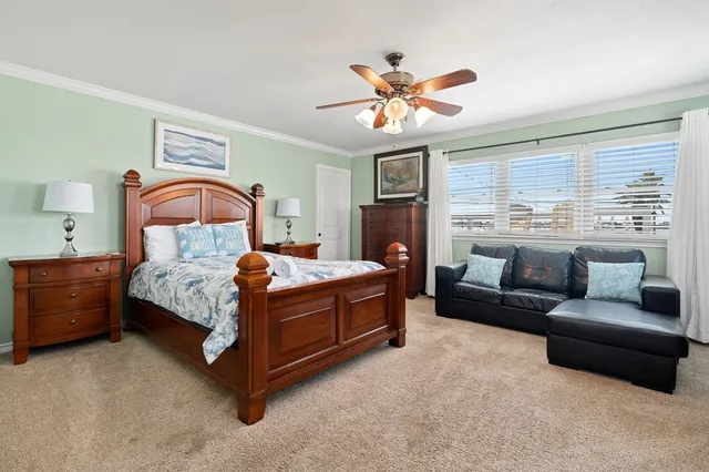 a bedroom with a bed couch and window