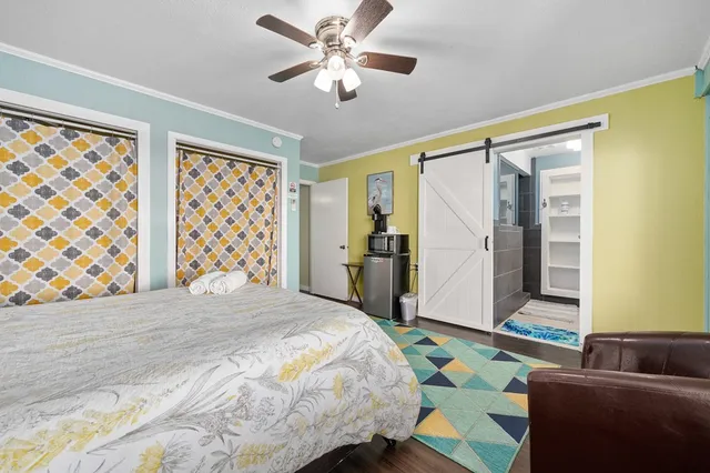 a bedroom with a bed and a couch