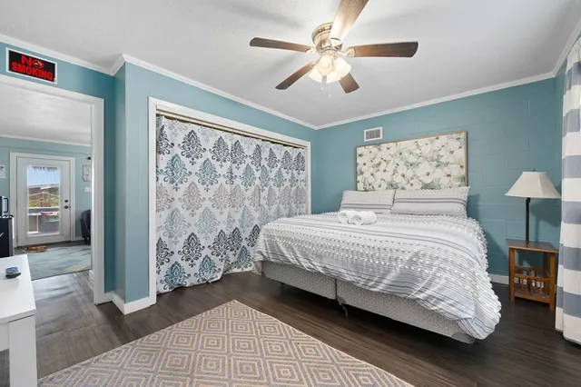 a bedroom with a large bed and a chandelier
