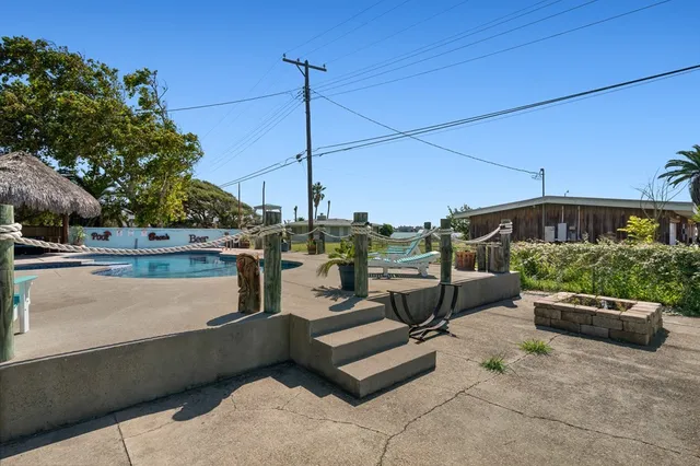 a view of a swimming pool and a yard