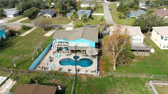 an aerial view of residential houses with outdoor space and parking