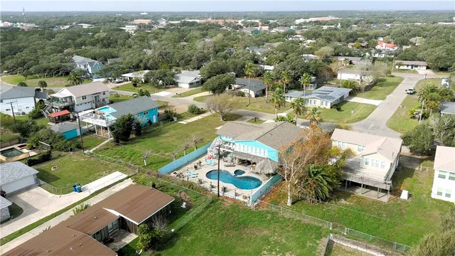 an aerial view of residential houses with outdoor space