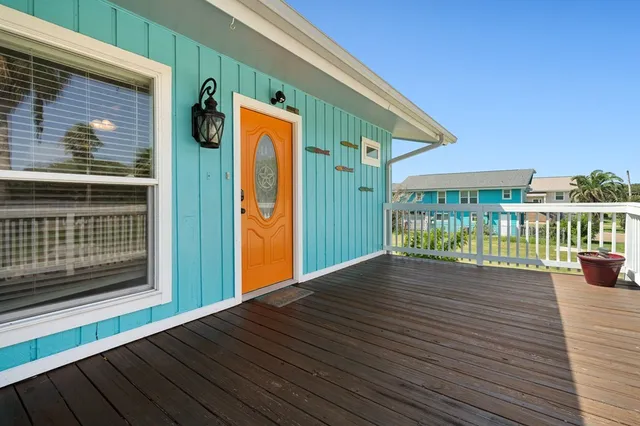 a view of backyard with deck and wooden floor