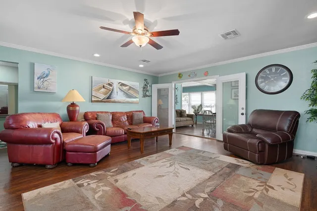 a living room with furniture ceiling fan and a rug
