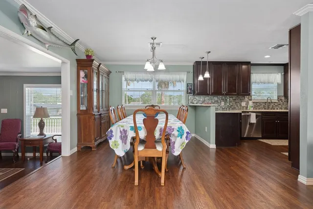a view of a dining room with furniture window and wooden floor