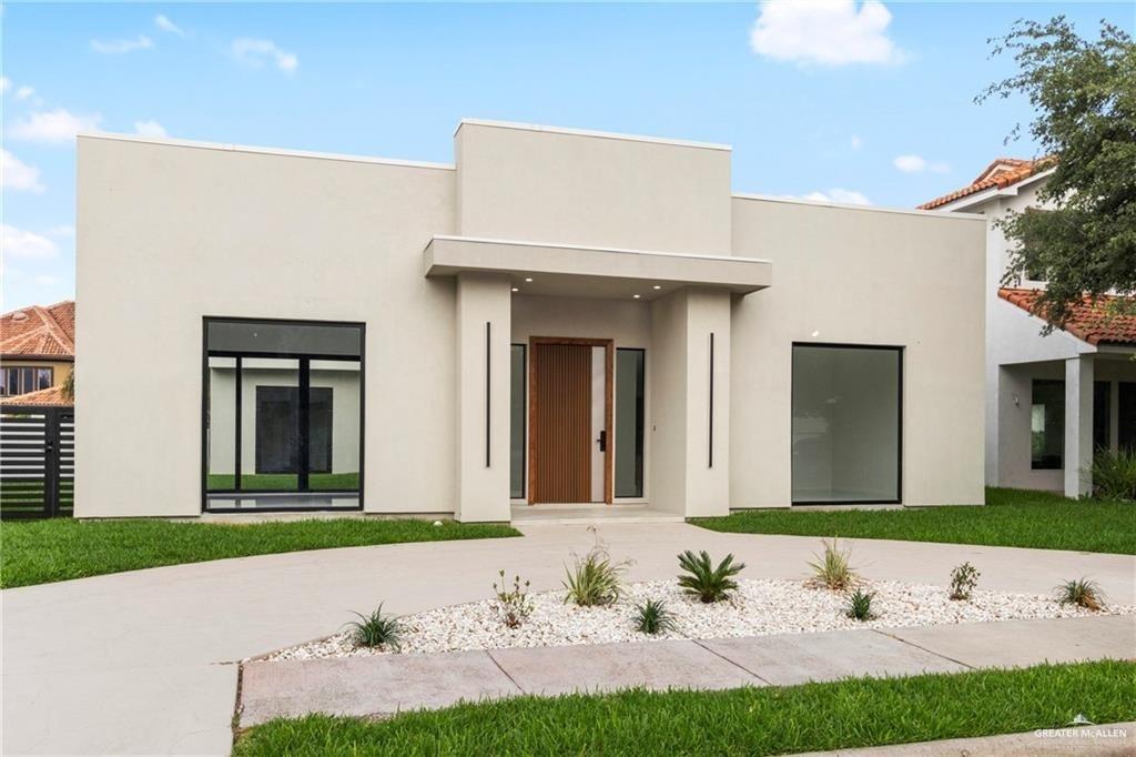 a front view of a house with a garden and yard