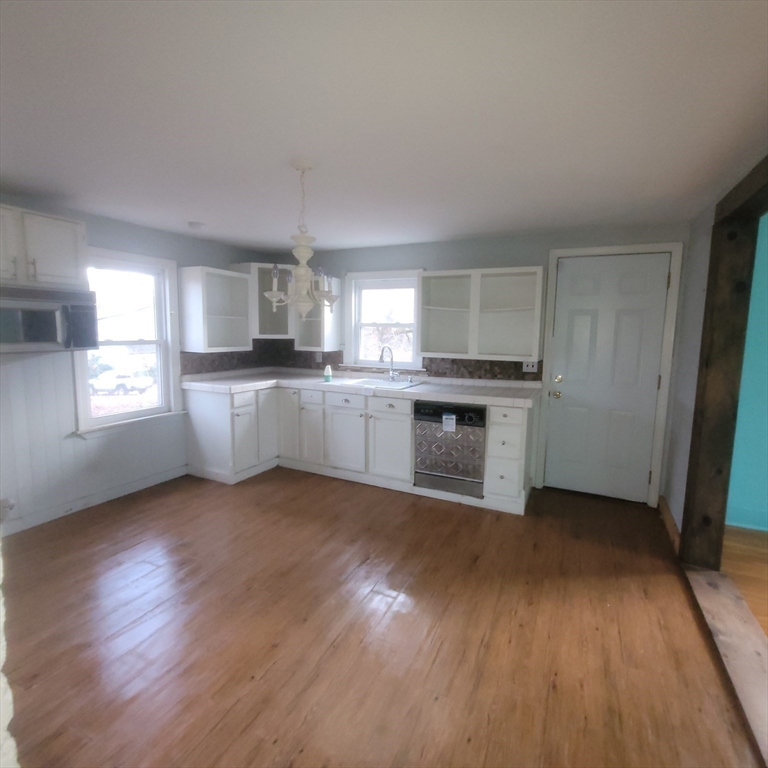 36 Wallace Road Sturbridge, MA 01566 - Photo 4 of 18 a kitchen with stainless steel appliances granite countertop a stove top oven a sink and dishwasher a refrigerator with wooden floor