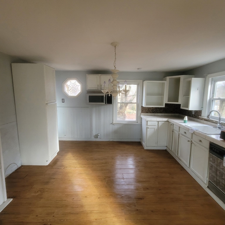 36 Wallace Road Sturbridge, MA 01566 - Photo 5 of 18 a kitchen with granite countertop a sink cabinets and wooden floor