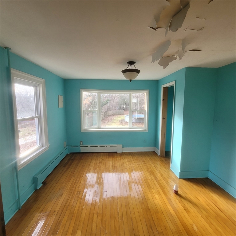 36 Wallace Road Sturbridge, MA 01566 - Photo 6 of 18 a view of empty room with wooden floor and fan