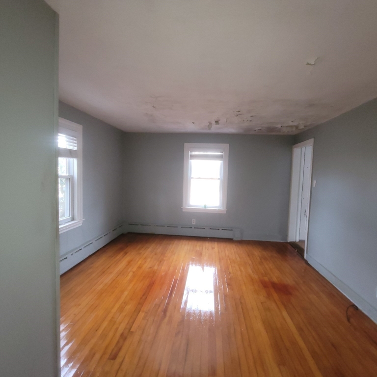 36 Wallace Road Sturbridge, MA 01566 - Photo 8 of 18 an empty room with wooden floor and windows