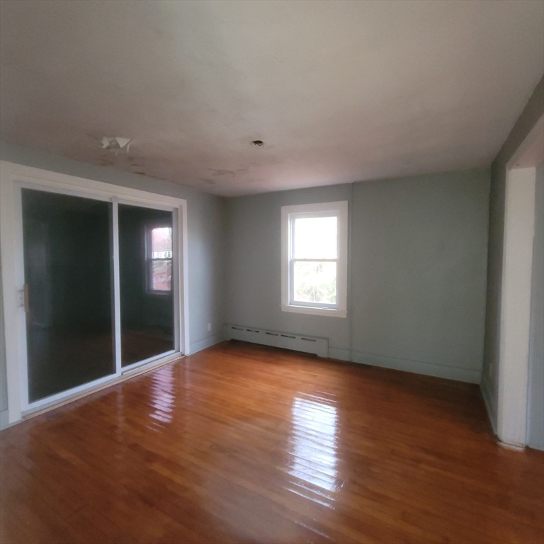 36 Wallace Road Sturbridge, MA 01566 - Photo 9 of 18 an empty room with wooden floor and windows