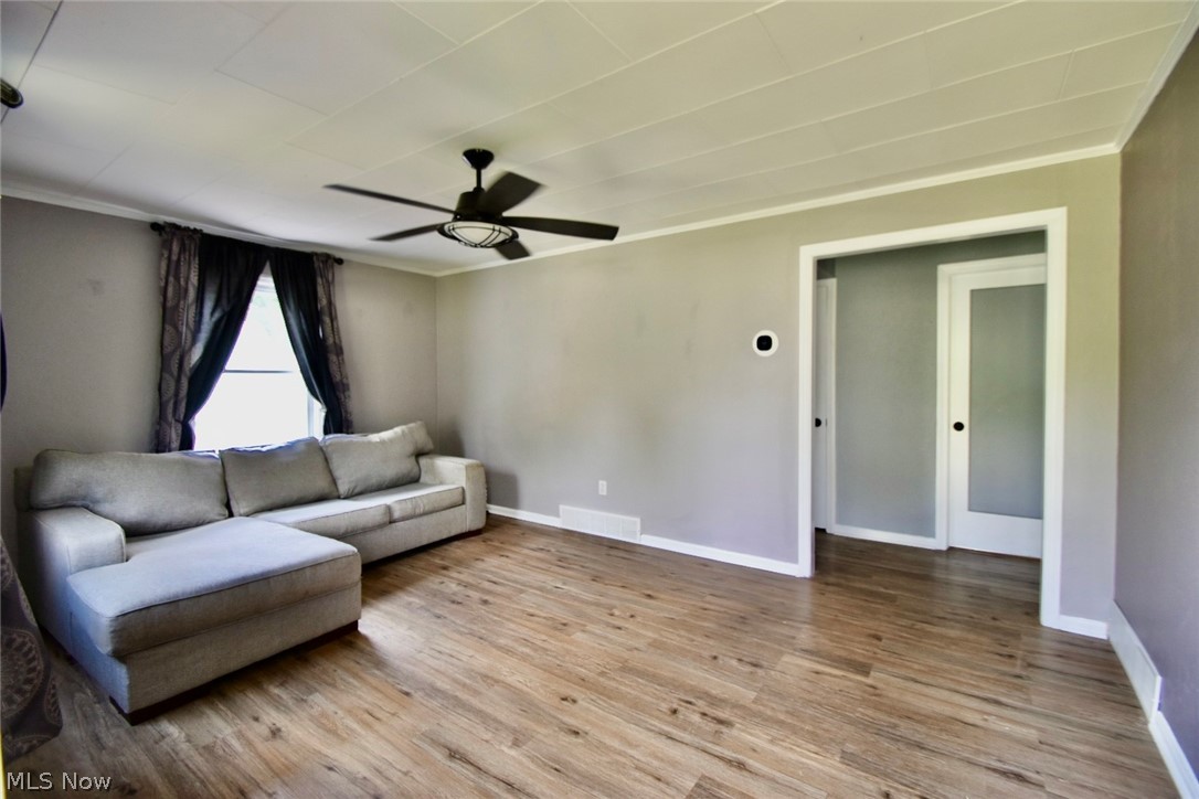 1053 Novak Road Grafton, OH 44044 - Photo 8 of 20 Living room featuring hardwood / wood-style floors, ceiling fan, and crown molding