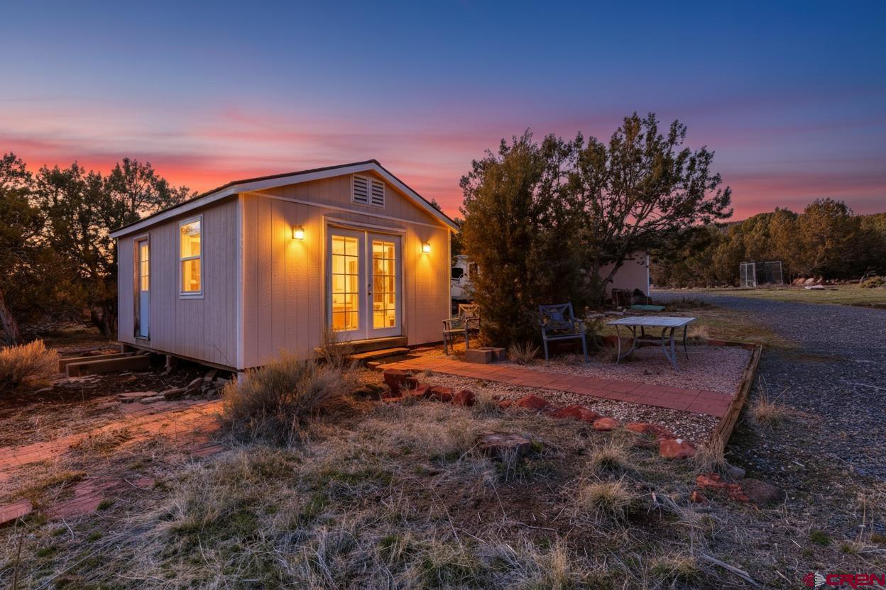 15444 3050th Road Hotchkiss, CO 81419 - Photo 3 of 18 a backyard of a house with table and chairs