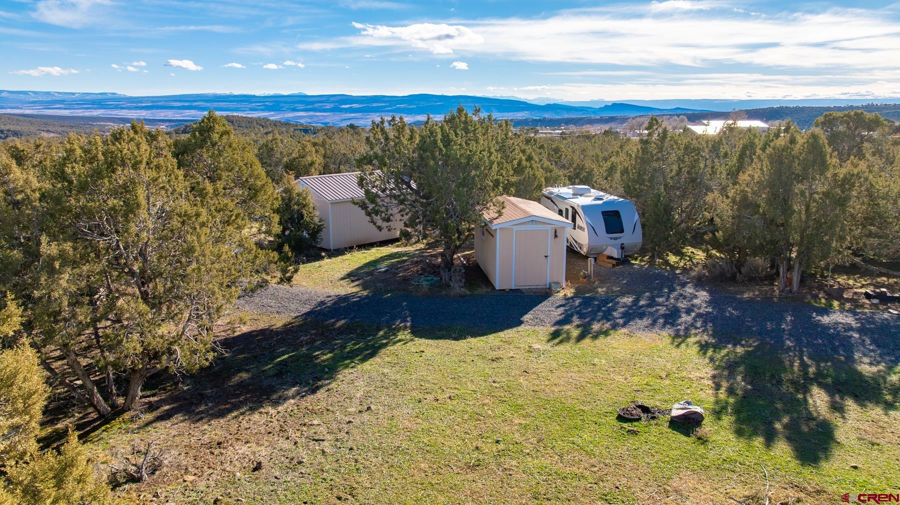 15444 3050th Road Hotchkiss, CO 81419 - Photo 4 of 18 a view of a swimming pool with a yard and mountain view