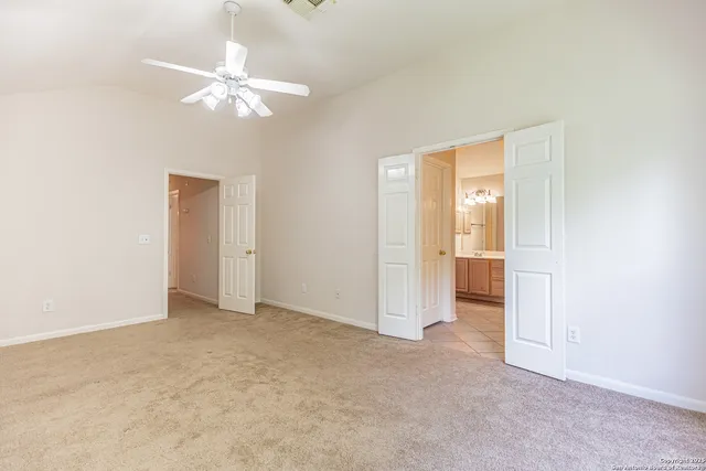 a spacious bathroom with a granite countertop sink toilet and shower