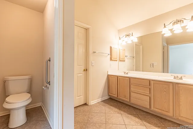 a bathroom with a sink double vanity granite and a bathtub