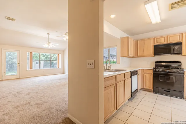 a kitchen with stainless steel appliances granite countertop a stove and a sink