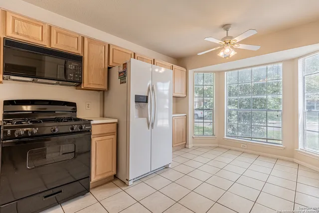 a kitchen with stainless steel appliances granite countertop a refrigerator oven a sink dishwasher and a refrigerator