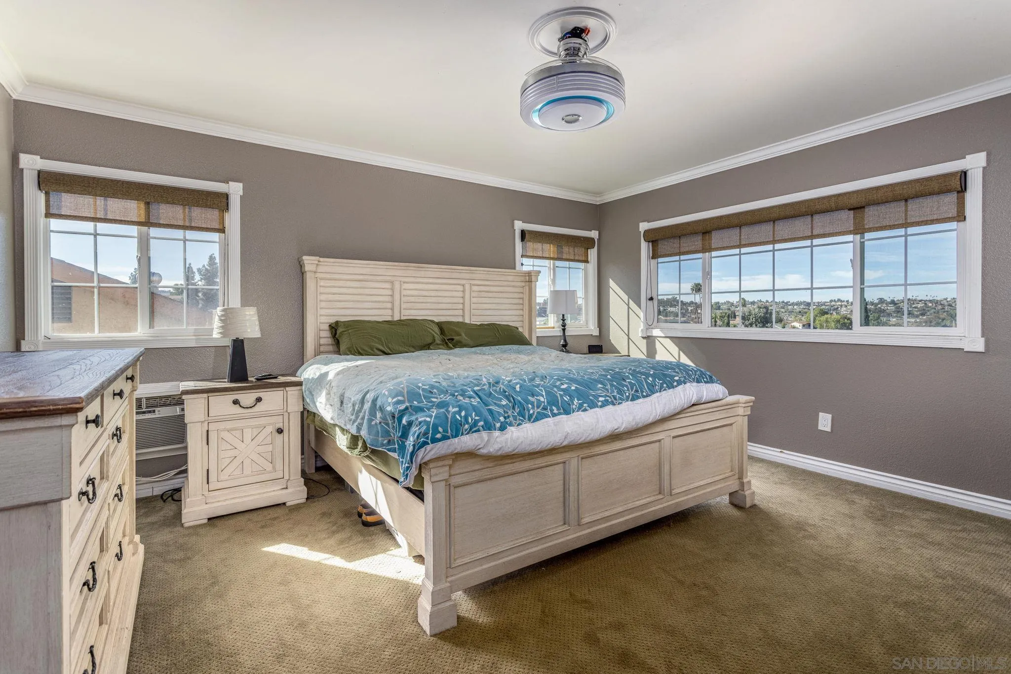 532 Kempton Street Spring Valley, CA 91977 - Photo 16 of 30 a bedroom with a large bed and a chandelier