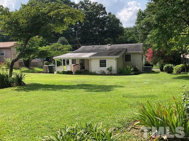 1309 Kelly Road Garner, NC 27529 - Photo 18 of 19 a front view of a house with a garden