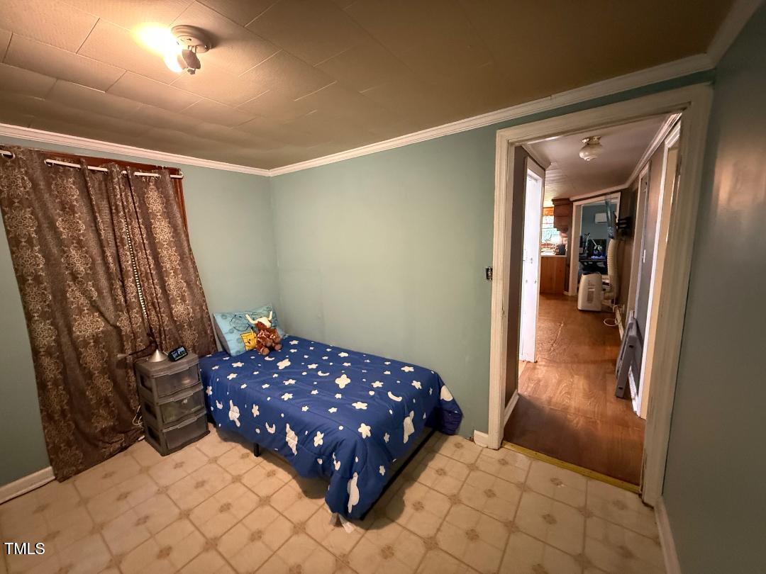 1196 Cash Road Creedmoor, NC 27522 - Photo 9 of 16 a bedroom with a bed and a rug