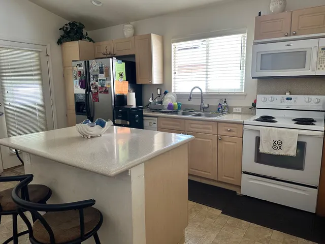 a kitchen with a stove a sink and cabinets