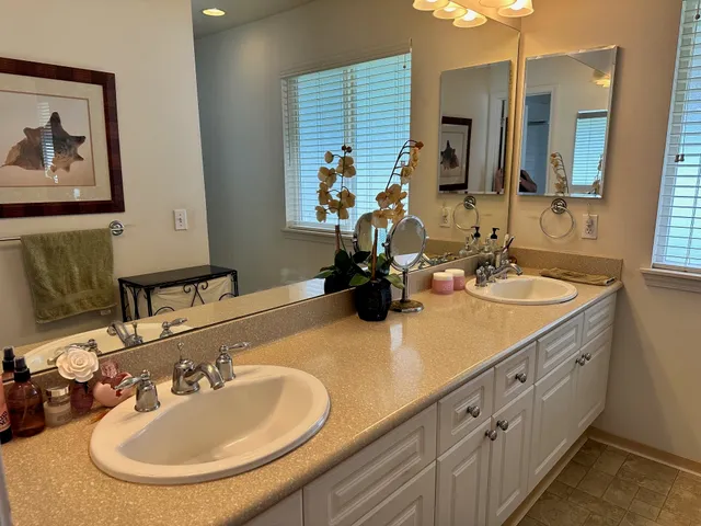 a bathroom with double vanity sinks and a mirror