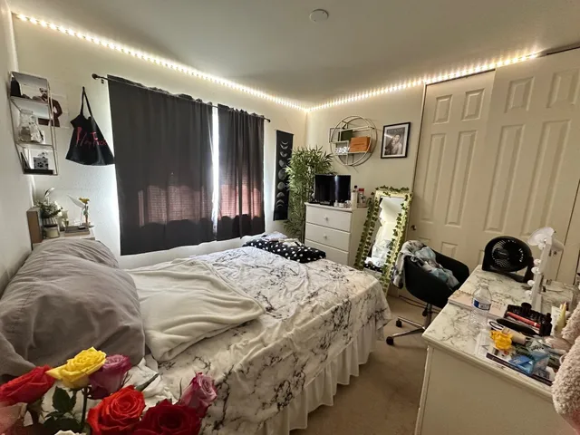 a bedroom with bed and a window