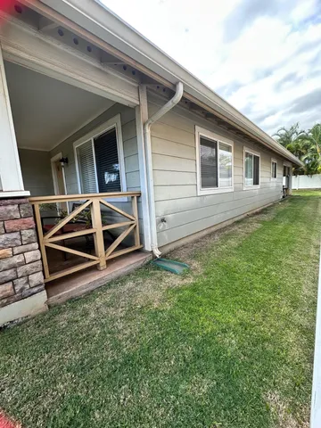 a backyard of a house with wooden floor and fence