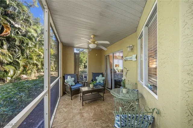 a balcony with furniture and a potted plant