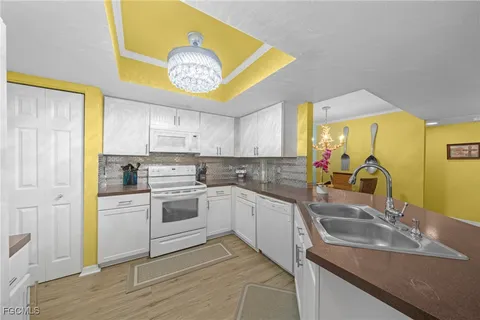 a kitchen with a sink cabinets and window