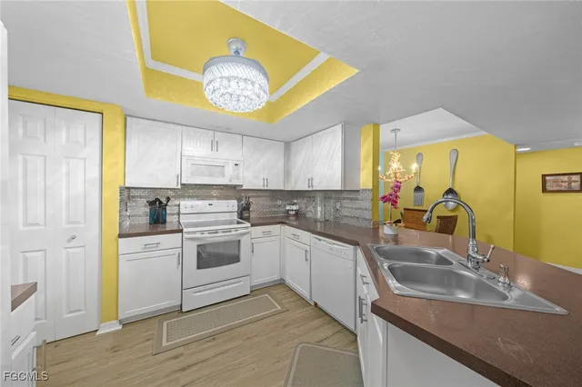 a kitchen with a sink cabinets and window