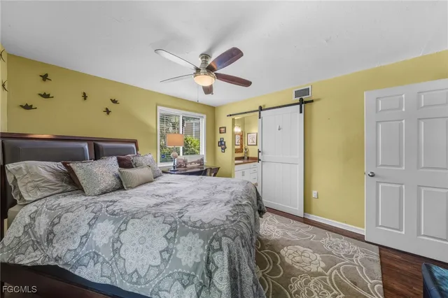 a spacious bedroom with a bed dresser and a window