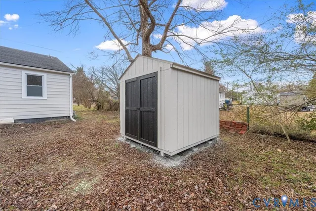a backyard of a house with table and chairs