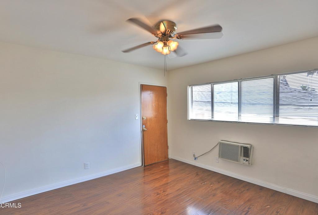 124 South Olive Avenue, Unit B Alhambra, CA 91801 - Photo 3 of 12 an empty room with wooden floor and windows