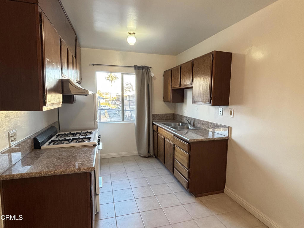 124 South Olive Avenue, Unit B Alhambra, CA 91801 - Photo 4 of 12 a kitchen with stainless steel appliances granite countertop a stove and a refrigerator